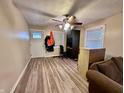 Inviting living room with laminate flooring, a ceiling fan, and ample natural light creating a comfortable space at 3932 Caroline Ave, Indianapolis, IN 46205