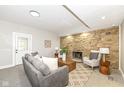Cozy living room featuring a stone fireplace, recessed lighting, and comfortable seating arrangement at 435 N Chestnut St, Monrovia, IN 46157