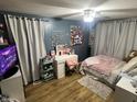 Cozy bedroom with wood flooring, and light-blocking curtains for a peaceful night's sleep at 4904 Betholm Dr, Indianapolis, IN 46239