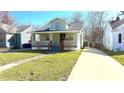 Charming two-story home featuring a long driveway and a well-manicured lawn at 4929 Kingsley Dr, Indianapolis, IN 46205