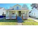 Inviting two-story home with covered front porch and well-maintained lawn at 4929 Kingsley Dr, Indianapolis, IN 46205