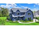 Attractive home exterior boasts lush lawn, mature trees, and well-maintained landscaping at 5120 Melbourne Pl, Zionsville, IN 46077
