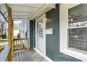Inviting front porch features detailed railings and a secure entry door at 5350 E 20Th Pl, Indianapolis, IN 46218