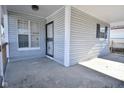 The porch area, complete with gray siding and white railings, offers a relaxing outdoor space at 553 N Traub Ave, Indianapolis, IN 46222