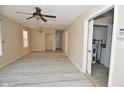 Open concept living room with new laminate flooring, ceiling fan and multiple windows at 553 N Traub Ave, Indianapolis, IN 46222