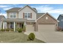 Attractive two-story home featuring a brick facade, symmetrical windows, and a well-manicured lawn at 5540 Arrowgrass Ct, Noblesville, IN 46062