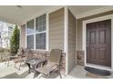 Inviting front porch with seating area and large windows providing ample natural light at 5540 Arrowgrass Ct, Noblesville, IN 46062