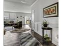 Open-concept living room with hardwood floors, stylish rugs, and a view of the backyard at 5540 Arrowgrass Ct, Noblesville, IN 46062