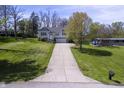 Desirable home featuring pristine landscaping, a long drive, and an attached garage, set on a large lot at 5836 Andover Rd, Indianapolis, IN 46220