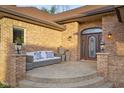 Inviting front porch features a seating area and decorative plants, creating a welcoming entrance at 6043 Acorn Dr, Columbus, IN 47201
