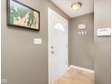 Inviting entryway with a white front door, tile flooring, and stylish wall decor at 6721 Evanston Ave, Indianapolis, IN 46220