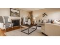 Bright living room featuring a fireplace, neutral furniture and lots of natural light at 7021 Warwick Rd, Indianapolis, IN 46220