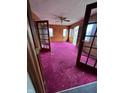 Bright sun room featuring knotty pine walls, french doors and windows allowing ample natural light to fill the room at 805 W 3Rd St, Alexandria, IN 46001