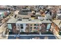 An aerial shot showcases townhome's roof and surrounding neighborhood, providing a sense of the property's location and community at 932 Broadway St # 15, Indianapolis, IN 46202