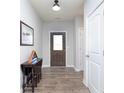 Inviting entryway with hardwood floors, a stylish console table, and a view of the front door at 981 Mound St, Bargersville, IN 46106