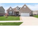 Charming single-story brick home with attached two-car garage and well-manicured lawn at 981 Mound St, Bargersville, IN 46106