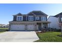Charming two-story home with a three-car garage and a well-manicured lawn, perfect for curb appeal at 10609 Banyan Wood Ct, Indianapolis, IN 46239