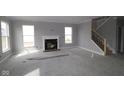 Open living room with fireplace and staircase, offering a bright and airy space at 10609 Banyan Wood Ct, Indianapolis, IN 46239