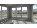 Bright room with three large windows showcasing the neighborhood view at 10609 Banyan Wood Ct, Indianapolis, IN 46239