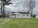 A single story home with light siding and a large front yard on an overcast day at 125 Ursal Ln, Greenwood, IN 46143