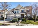 Inviting two-story home with a neatly manicured lawn, a mailbox, and a welcoming front entrance at 12729 Brandenburg Dr, Carmel, IN 46032