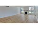 Spacious open-plan living room with light hardwood flooring and a cozy fireplace area at 14402 Allison Dr, Carmel, IN 46033