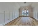 Bright living room boasts beautiful hardwood floors, crown molding, and a statement chandelier at 14402 Allison Dr, Carmel, IN 46033