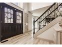 Inviting entryway featuring a modern staircase, sleek floors, and abundant natural light at 1448 Sedona Dr, Carmel, IN 46032