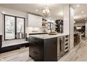 Modern kitchen featuring a central island with a wine fridge, sleek cabinets and stainless steel appliances at 1448 Sedona Dr, Carmel, IN 46032