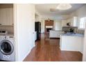 Bright kitchen featuring white cabinets, stainless steel appliances, and hardwood flooring at 14573 Waverly Dr, Carmel, IN 46033