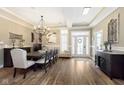 Elegant dining room features hardwood floors, stylish chandelier, and large windows at 15254 Kampen Cir, Carmel, IN 46033