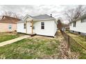 Quaint one-story home with white siding and a small front porch in a residential neighborhood at 1640 W 7Th St, Anderson, IN 46016
