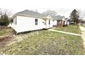 A cozy home featuring vinyl siding and a well-maintained lawn at 1640 W 7Th St, Anderson, IN 46016
