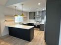 Modern kitchen with gray cabinets, stainless steel appliances, and a stylish island at 1716 E Kelly St, Indianapolis, IN 46203