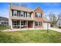 Charming two-story home featuring a covered porch and a mix of brick and siding exterior at 17918 Lucas Cir, Westfield, IN 46074