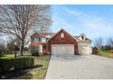 Charming two-story home featuring a brick facade, attached two-car garage, and well-manicured lawn at 18358 Benton Oak Dr, Noblesville, IN 46062