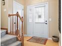 Bright foyer with hardwood floors, staircase, and front door, offering a welcoming entrance at 18358 Benton Oak Dr, Noblesville, IN 46062