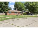 A well-kept single-story brick home with neat landscaping, charming shutters, and a convenient attached garage at 1906 E Markwood Ave, Indianapolis, IN 46227