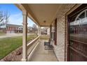 Inviting covered front porch with decorative columns offering a cozy outdoor seating area and neighborhood views at 1975 Westminster Pl, Columbus, IN 47201