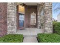 Inviting covered front porch with stone columns and seating area, perfect for relaxing at 2091 Banburry Pl, Avon, IN 46123