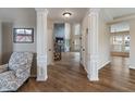 Elegant hallway with hardwood floors, leading to a living room with ample natural light at 2091 Banburry Pl, Avon, IN 46123