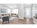 Inviting living room featuring a modern sofa, neutral decor, and plenty of natural light at 2425 Silver E Ct, Carmel, IN 46033