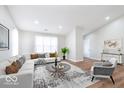 Spacious living room with plenty of natural light, vaulted ceiling and modern decor at 2425 Silver E Ct, Carmel, IN 46033