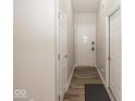 Hallway features modern wood floors and neutral paint at 3013 Crimson W Ct # 42, Carmel, IN 46033