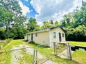 Side view of house with chain link fence and lush lawn on a sunny day at 3201 N Hawthorne Ln, Indianapolis, IN 46218