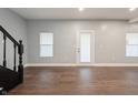 Spacious living room with wood floors and a door leading outside at 350 N Belleview Pl, Indianapolis, IN 46222