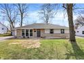 Charming single-story home with stone accents, a well-maintained lawn, and mature trees at 5887 Meadowlark Dr, Indianapolis, IN 46226