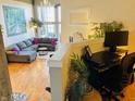 Comfortable living room featuring hardwood floors, plush seating and ample natural light at 611 N Park Ave # 405, Indianapolis, IN 46204