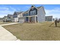 Suburban home with blue siding, a two-car garage, and a spacious yard, set in a Gathering-friendly neighborhood at 629 Washington St, Fortville, IN 46040