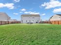 Spacious backyard with a well-maintained lawn, surrounded by a wooden fence for privacy and outdoor activities at 6746 Wilmot Ln, Avon, IN 46123